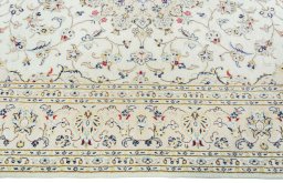 Corner detail of 2000s Kashan rug showing border pattern and Wool pile