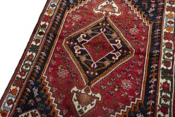 Backside of handmade 2000s Shiraz rug showing knot structure and weave density