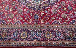 Corner detail of New Kashan rug showing border pattern and Wool pile