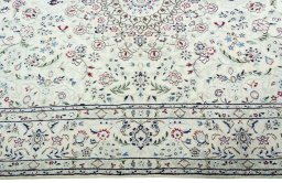 Corner detail of 2000s Nain rug showing border pattern and Wool pile