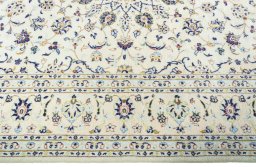 Corner detail of New Kashan rug showing border pattern and Wool pile