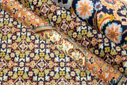 Corner detail of 1990s Tabriz Silk rug showing border pattern and Wool pile