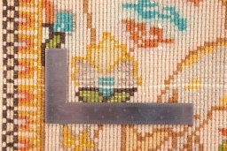 Corner detail of 2000s Tabriz Silk rug showing border pattern and Wool pile