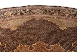 Corner detail of 2020s Tabriz Silk rug showing border pattern and Wool pile