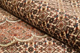 Backside of handmade New Tabriz Silk rug showing knot structure and weave density