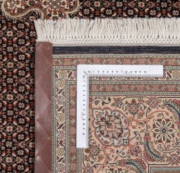Backside of handmade New Tabriz Silk rug showing knot structure and weave density