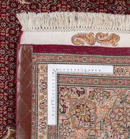 Backside of handmade New Tabriz Silk rug showing knot structure and weave density