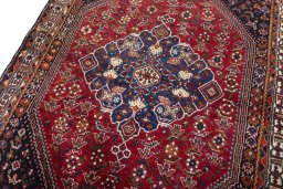 Backside of handmade 2000s Shiraz rug showing knot structure and weave density