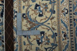 Backside of handmade 2000s Nain rug showing knot structure and weave density