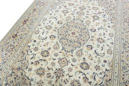 Backside of handmade New Kashan rug showing knot structure and weave density