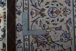 Backside of handmade 2000s Kashan rug showing knot structure and weave density