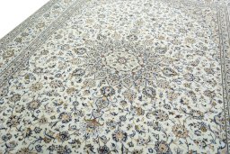 Backside of handmade 2000s Kashan rug showing knot structure and weave density