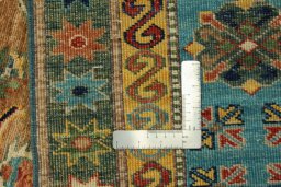 Backside of handmade New Kazak rug showing knot structure and weave density