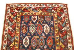 Surface texture of 1900s Kazak rug with natural Wool and intricate pattern
