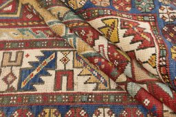 Corner detail of 1900s Kazak rug showing border pattern and Wool pile