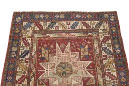 Surface texture of 1900s Kazak rug with natural Wool and intricate pattern