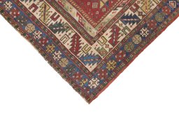 Backside of handmade 1900s Kazak rug showing knot structure and weave density