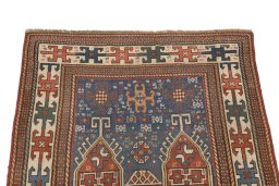 Surface texture of 1900s Kazak rug with natural Wool and intricate pattern