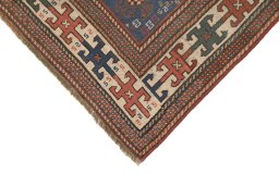 Backside of handmade 1900s Kazak rug showing knot structure and weave density