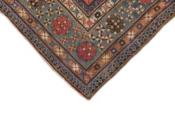 Backside of handmade 1900s Kazak rug showing knot structure and weave density