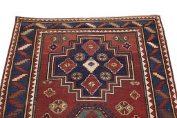 Surface texture of 1900s Kazak rug with natural Wool and intricate pattern