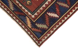 Backside of handmade 1900s Kazak rug showing knot structure and weave density