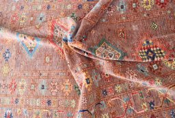 Backside of handmade New Kazak rug showing knot structure and weave density