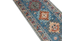 Backside of handmade New Kazak rug showing knot structure and weave density