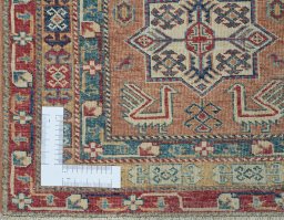 Corner detail of New Kazak rug showing border pattern and Wool pile