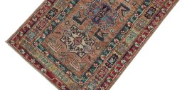 Backside of handmade New Kazak rug showing knot structure and weave density