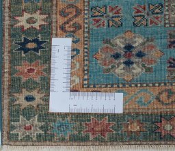 Corner detail of New Kazak rug showing border pattern and Wool pile