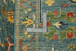 Backside of handmade New Kazak rug showing knot structure and weave density