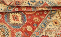 Corner detail of New Kazak rug showing border pattern and Wool pile