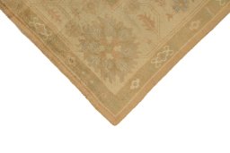 Backside of handmade 1920s Oushak rug showing knot structure and weave density