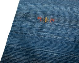 Backside of handmade New Persian Gabbeh rug showing knot structure and weave density