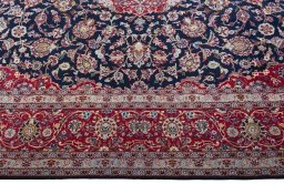 Corner detail of 2000s Kashan rug showing border pattern and Cork pile