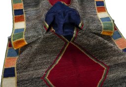 Corner detail of 1970s Persian Gabbeh rug showing border pattern and Wool pile