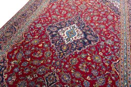 Backside of handmade 2000s Kashan rug showing knot structure and weave density