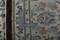 Backside of handmade 2000s Kashan rug showing knot structure and weave density