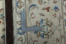 Backside of handmade New Kashan rug showing knot structure and weave density