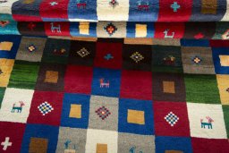 Full view of 2000s Persian Gabbeh rug from Pakistan, 220 × 143 cm in Multi Color tones