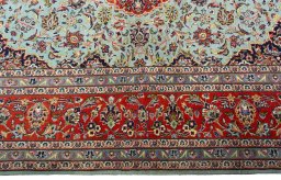 Corner detail of New Kashan rug showing border pattern and Cork pile