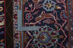 Backside of handmade 2000s Kashan rug showing knot structure and weave density