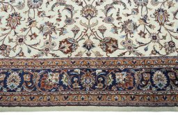 Corner detail of 2000s Mashad rug showing border pattern and Wool pile