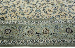 Corner detail of 2000s Kashan rug showing border pattern and Cork pile