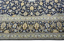 Corner detail of 2000s Kashan rug showing border pattern and Wool pile