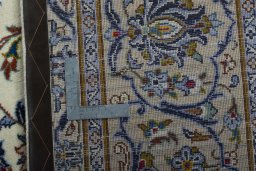 Backside of handmade 2000s Kashan rug showing knot structure and weave density