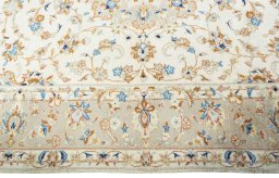 Corner detail of New Kashan rug showing border pattern and Wool pile