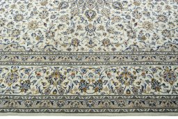 Corner detail of 2000s Kashan rug showing border pattern and Wool pile