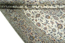 Corner detail of 2000s Kashan rug showing border pattern and Wool pile